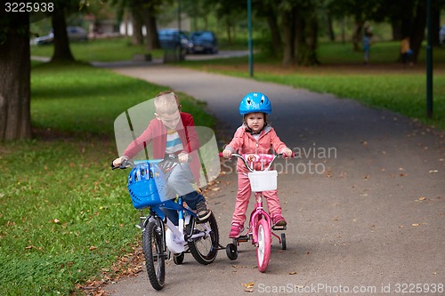 Image of boy and girl with bicycle