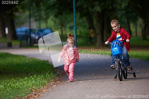 Image of boy and girl with bicycle