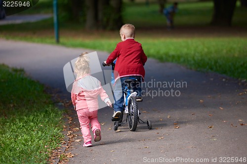 Image of boy and girl with bicycle