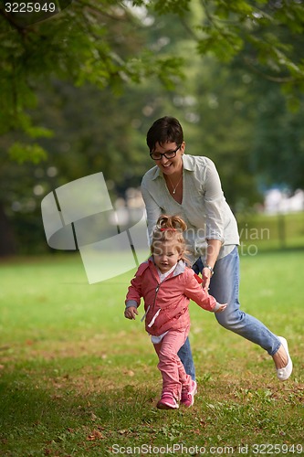 Image of happy family playing together outdoor in park