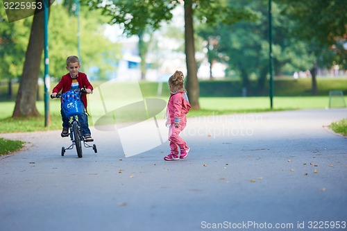 Image of boy and girl with bicycle