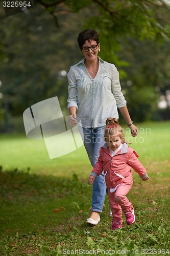 Image of happy family playing together outdoor in park