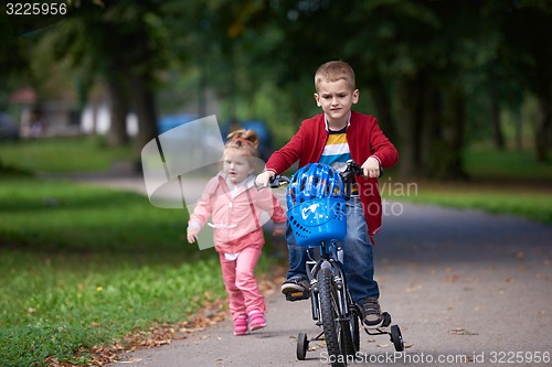 Image of boy and girl with bicycle