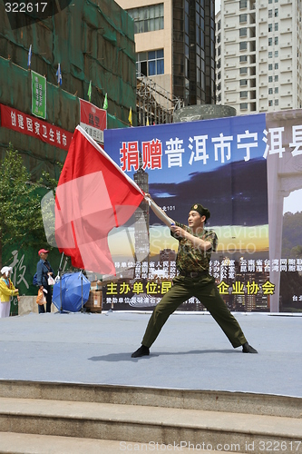 Image of Chinese soldier waving a red flag