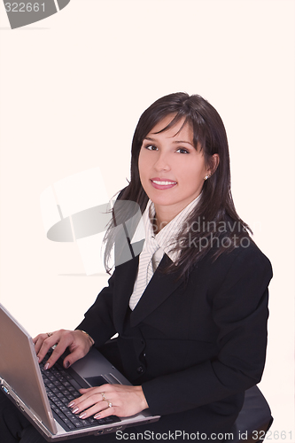 Image of Smilling brunette working on a laptop