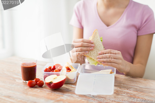 Image of close up of woman with food in plastic container