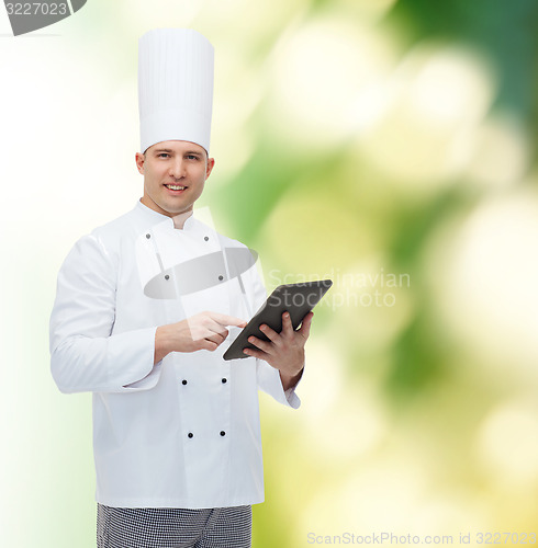 Image of happy male chef cook holding tablet pc