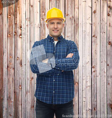 Image of smiling male builder or manual worker in helmet