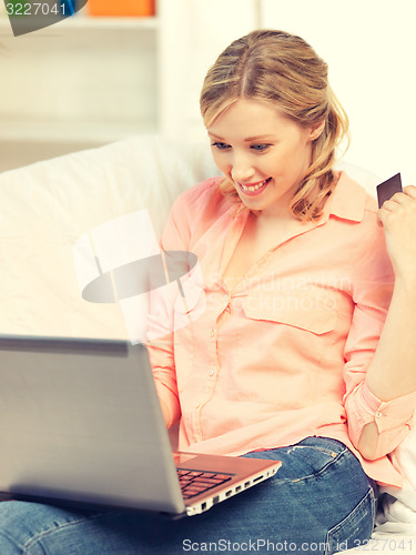 Image of happy woman with laptop computer and credit card