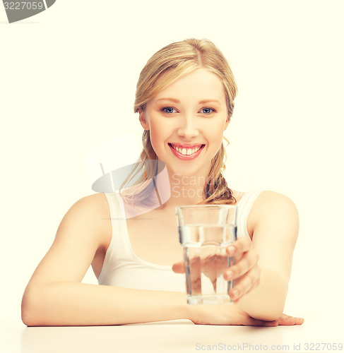 Image of young smiling woman with glass of water