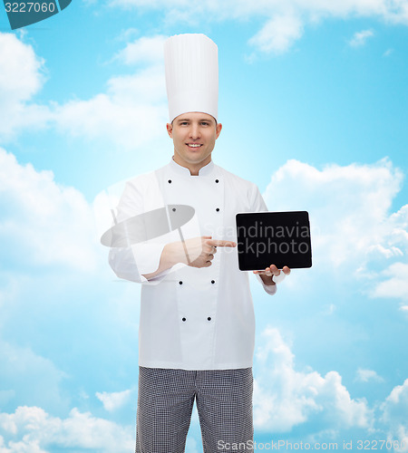Image of happy male chef cook showing tablet pc