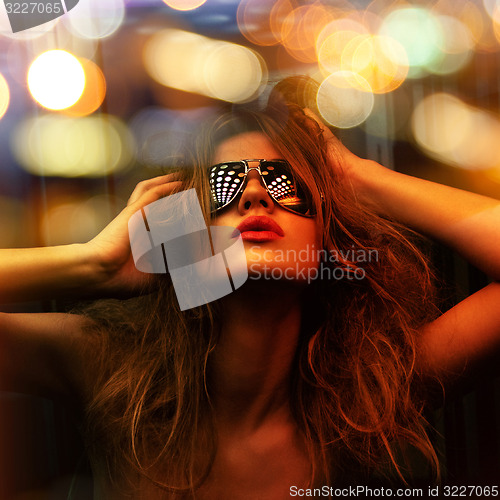 Image of fashionable woman in nightclub