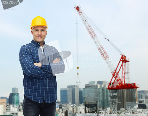 Image of smiling male builder or manual worker in helmet