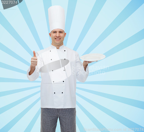 Image of happy male chef cook showing thumbs up and plate