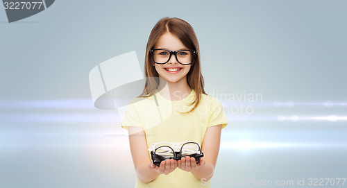 Image of smiling cute little girl in black eyeglasses