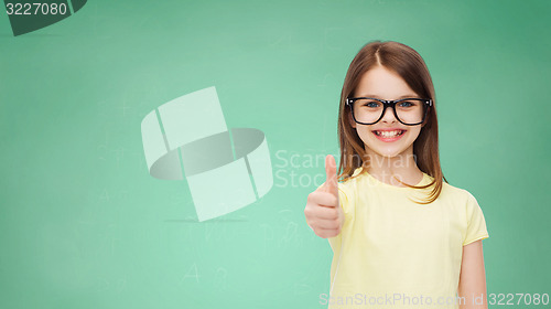 Image of smiling cute little girl in black eyeglasses