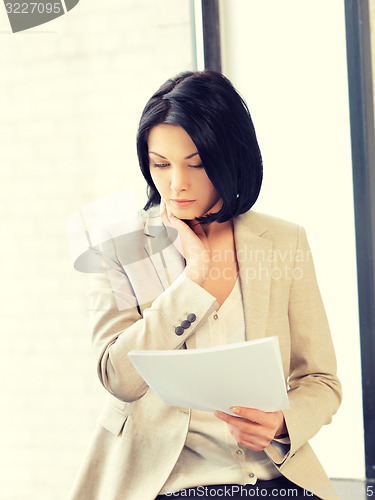 Image of calm woman with documents