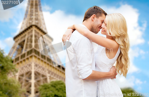 Image of happy couple hugging over eiffel tower