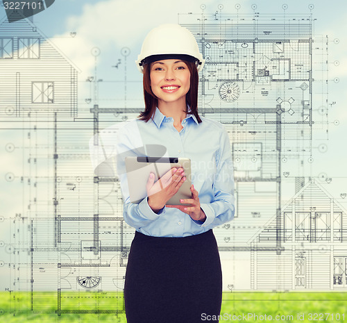 Image of young smiling businesswoman in white helmet