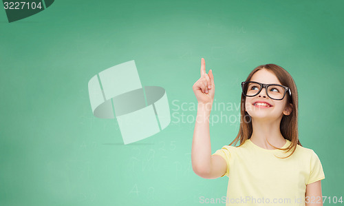 Image of smiling cute little girl in black eyeglasses