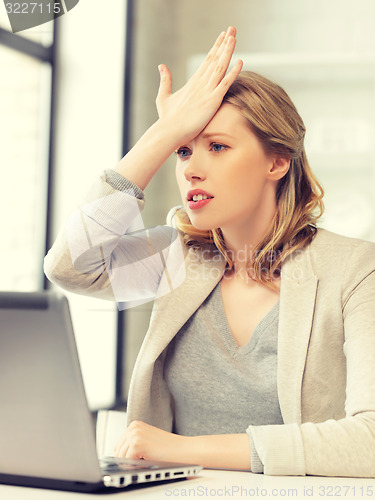 Image of stressed woman with laptop computer