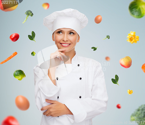 Image of smiling female chef dreaming