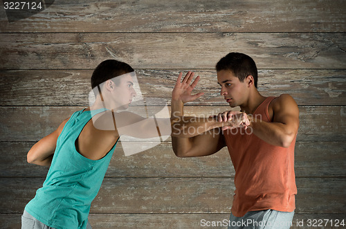 Image of young men fighting hand-to-hand