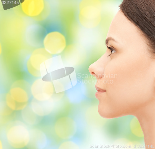 Image of beautiful young woman face over green background