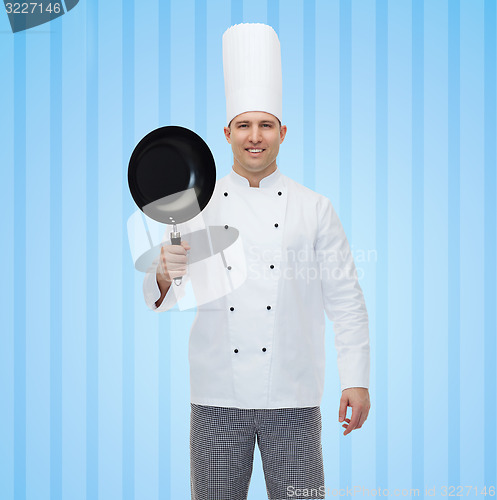 Image of happy male chef cook holding frying pan