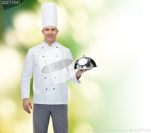 Image of happy male chef cook holding cloche