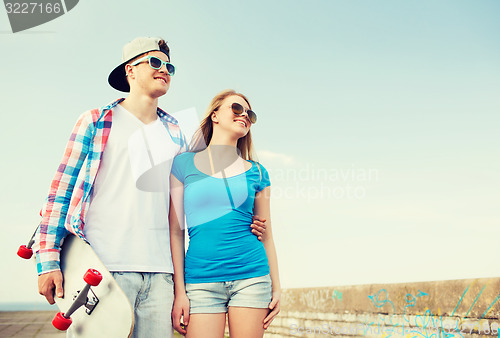 Image of smiling couple having fun outdoors