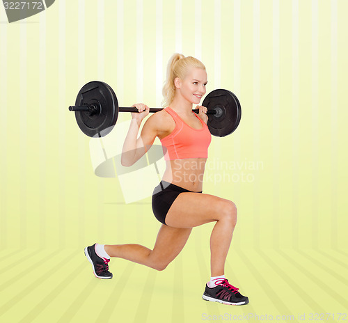 Image of sporty woman exercising with barbell