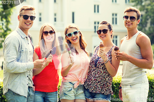 Image of group of smiling friends with ice cream outdoors