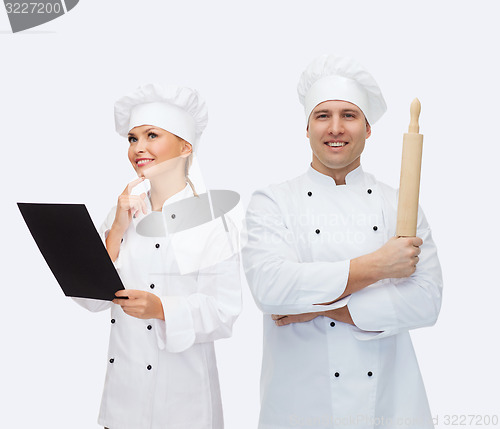 Image of happy male chef cook holding rolling pin