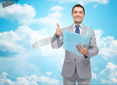 Image of happy businessman with folder showing thumbs up