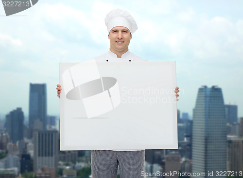 Image of happy male chef cook holding white blank big board