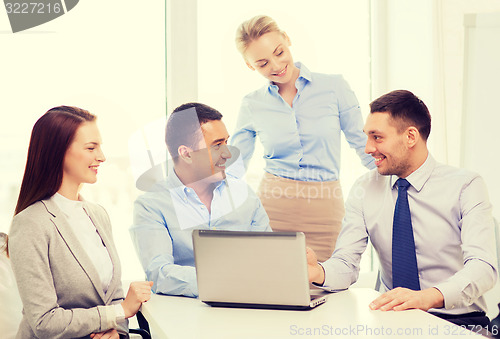 Image of business team working with laptop in office