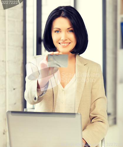 Image of happy woman with laptop computer and credit card