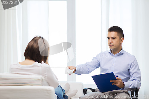 Image of doctor and young woman meeting at home visit