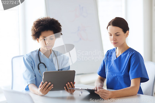 Image of doctors with tablet pc meeting at hospital