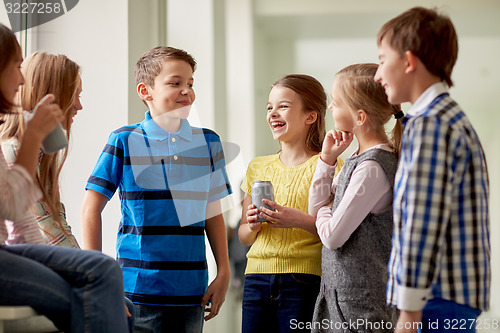 Image of group of school kids with soda cans in corridor
