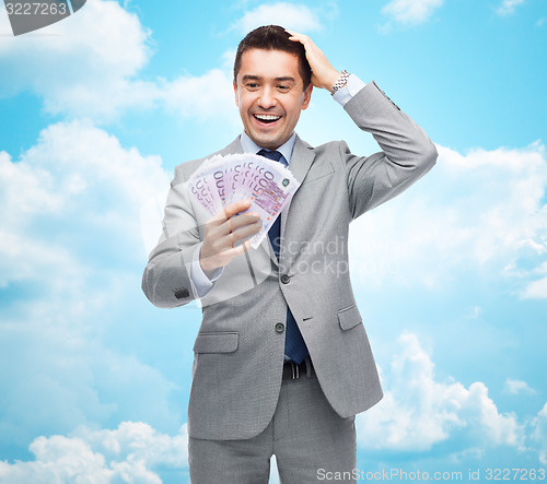 Image of happy laughing businessman with euro money