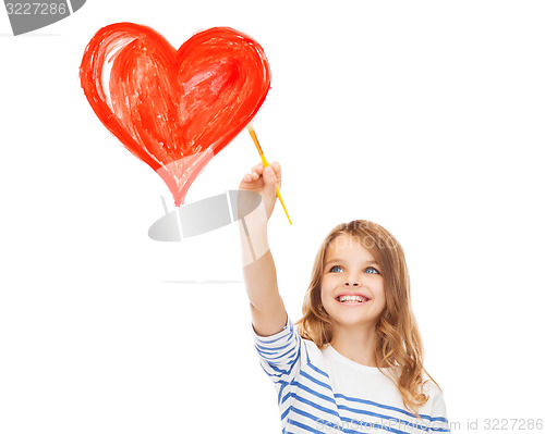 Image of cute little girl drawing heart with brush