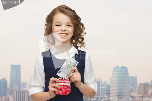 Image of happy girl with purse and paper money