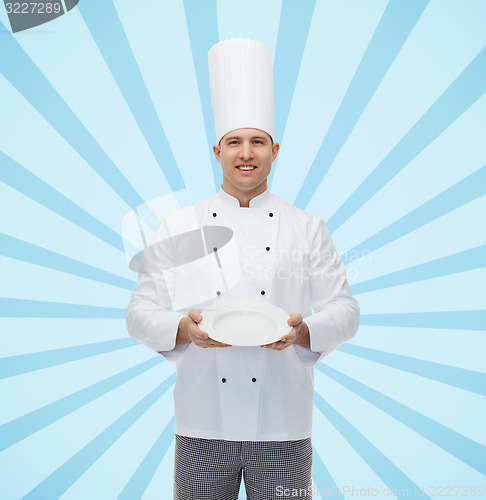 Image of happy male chef cook showing empty plate