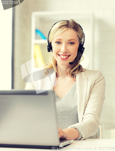 Image of friendly female helpline operator with laptop