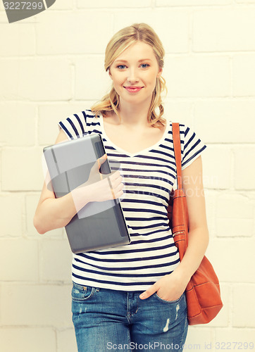 Image of happy and smiling teenage girl with laptop