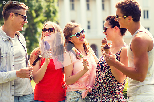 Image of group of smiling friends with ice cream outdoors