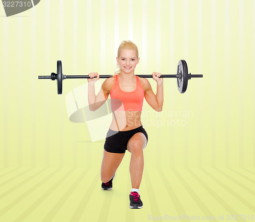 Image of sporty woman exercising with barbell