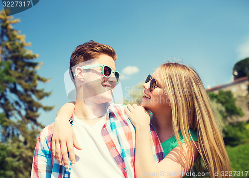 Image of smiling couple having fun outdoors